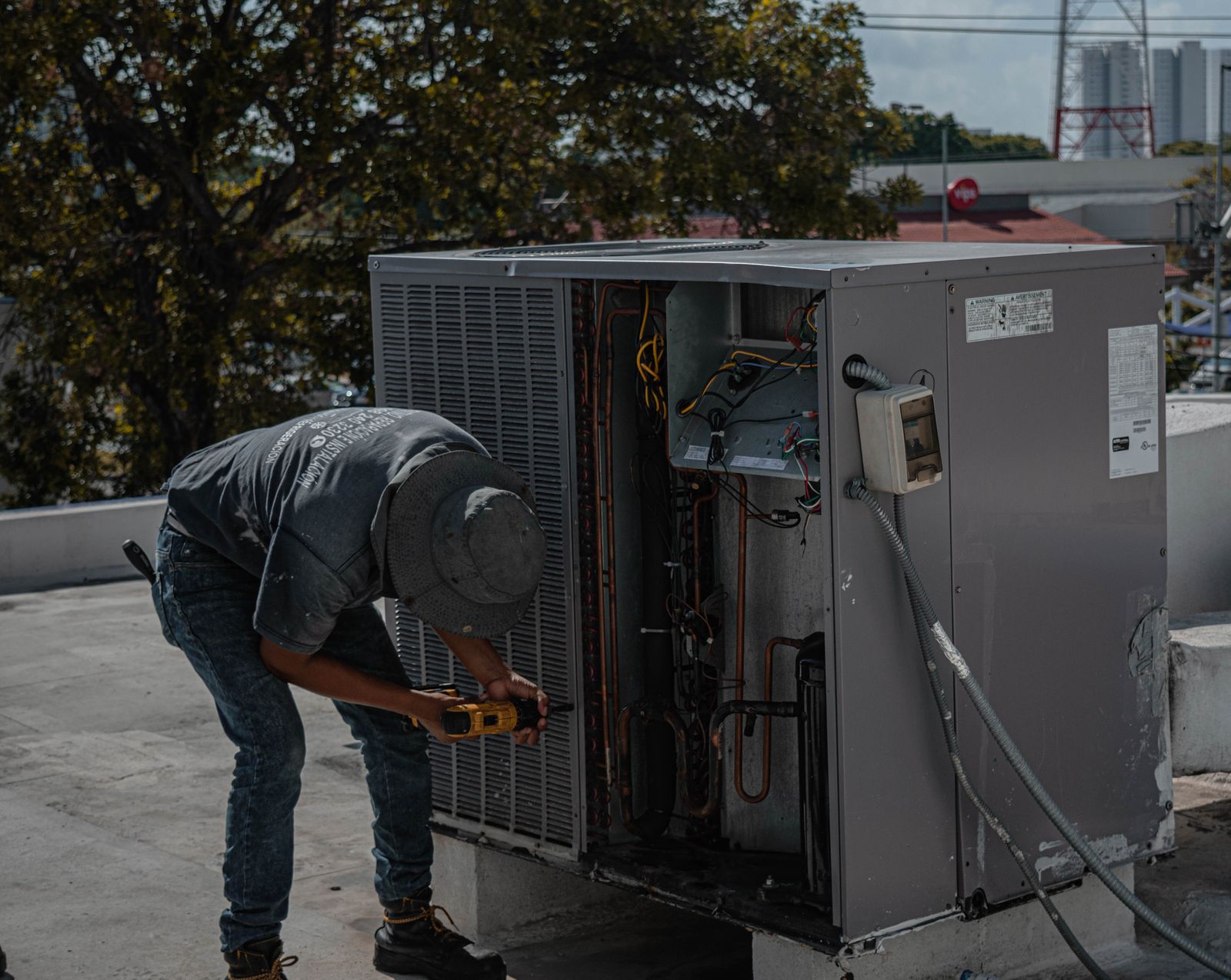 HVAC technician at work on rooftop unit
